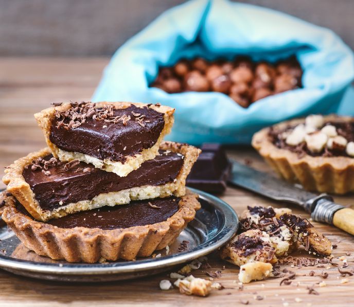 Vegan chocolate ganache tarts on a table