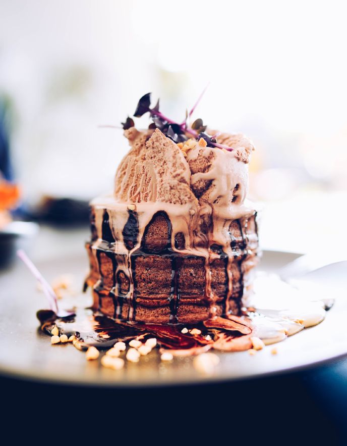 Tiramisu pancakes stacked with chocolate sauce and ice cream